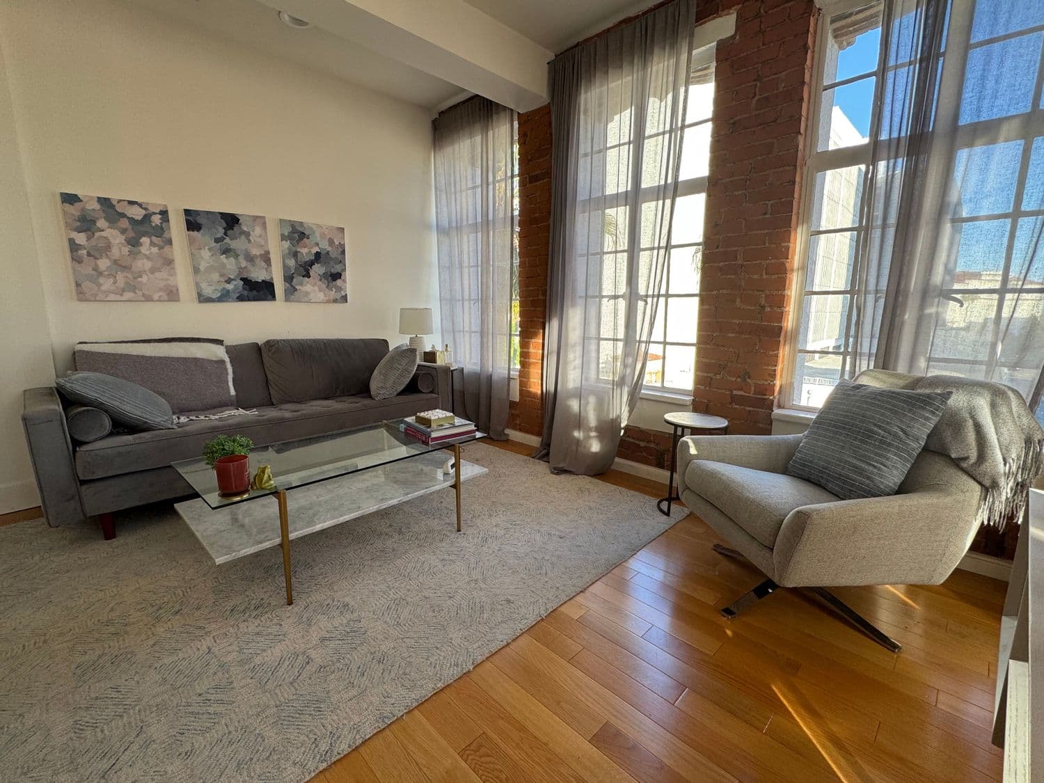 Bright therapy room with gray sofa and bookshelves