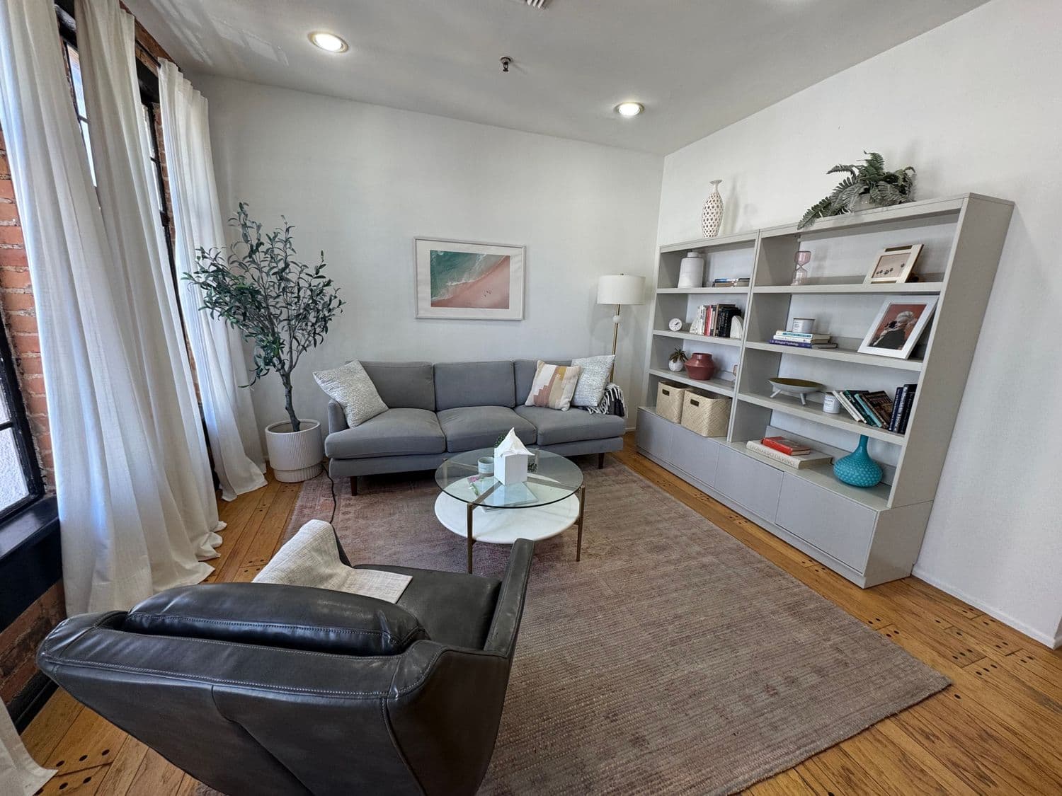 Cozy therapy space with large windows and natural light